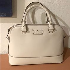 9 Inch Height, 13 Inch Width Across One Side, 4,5 Inch Depth . Nwot, Comes With Crossbody Strap. Ivory White 100% Cow Leather Exterior. Pink Polka Dot Interior. With Dust Bag. Classic White Handheld Bag, White Handheld Bag With Gold-tone Hardware, White Formal Satchel With Handles, Formal White Satchel With Handles, White Formal Satchel, Formal White Satchel, Kate Spade Cream Bag With Detachable Handle, Kate Spade Cream Bag With Gold-tone Hardware, Kate Spade Cream Crossbody Shoulder Bag