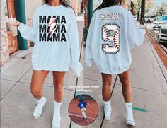 This Custom Mom Baseball Sweatshirt is perfect for showing your love and support for your child during Baseball season! The sweatshirt comes with MAMA on front and personalized on the back with your child's name and number! This Baseball Mom Shirt is a perfect Baseball Sweater for Mom to wear for the entire Baseball Season. Give any Sports Mom a gift she will love and use for her little ones.  ---------------------------------------------------------------------------- { S H I R T / D E T A I L S } Our sweatshirts are SUPER soft and SUPER comfy. They are UNISEX style! Make sure to choose your size accordingly! Please see images for sizing details. Please measure your current shirts that fit well and match up to our size charts for a better idea on sizing for you. -------------------------- Customizable Blue Varsity Top, Blue Customizable Varsity Tops, Athletic Heather Long Sleeve T-shirt With Letter Print, Long Sleeve T-shirt For Baseball Game Day, Sports Fan Long Sleeve Tops For Streetwear, Long Sleeve Tops For Sports Fans Streetwear, Long Sleeve Tops With Team Name For Sports Events, Sports Event Long Sleeve Tops With Team Name, Long Sleeve Sports Event Tops With Team Name