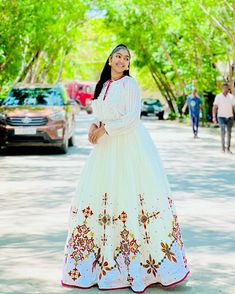 This Habesha Kemis is a true masterpiece of traditional Ethiopian fashion, with its exquisite Menen fabric and intricate Tilf design. The Menen fabric is renowned for its softness and durability, making this Kemis not only beautiful but also comfortable to wear. The Tilf design is intricate and delicate, with a pattern that is both modern and traditional, with clean lines and bold shapes that create a unique and eye-catching look. The Tilf design extends down the front of the Kemis, creating a v Ethiopian Fashion, Eritrean Dress, Habesha Dress, Habesha Kemis, Traditional Jewelry, A Pattern, Formal Event, Clean Lines, Timeless Fashion