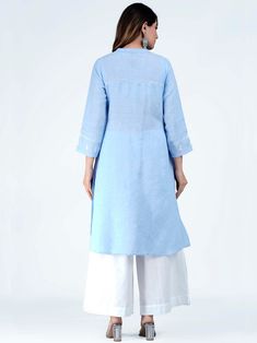 The very beautiful hand embroidered Linen-cotton tunic or kurta, available on demand (made to order) and customizable.Sizing: Please refer to our Size Chart to find your sizeThe item features55% Linen 45% CottonRound mandarin like collar with V slitLong tunic for culottes, leggings or pants3/4 sleevesAverage length (short): 32 in; Length customizableAverage length (long): 45 in; Length customizableLength of product may slightly vary as per the sizes. Please note: smaller size may be slightly sho Spring Linen Kurta With Chikankari Embroidery, Linen Straight Kurta With Resham Embroidery, Linen Kurta With Resham Embroidery, Straight Linen Kurta With Resham Embroidery, Festive Straight Kurta With Embroidered Hem, Blue Straight Kurta Tunic For Spring, Summer Straight Kurta With Embroidered Hem, Long Sleeve Linen Kurta With Chikankari Embroidery, Blue Floral Embroidered Tunic Kurta