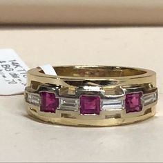 14k Yellow Gold Ladies Band Size 6.5. The Band Contains 3 Baguette Cut Diamonds Set East To West With A Weight Of 0.25 Carats And 3 Princess Cut Rubies With A Weight Of 0.70 Carats. The Ring Can Be Sized To Your Finger .An Appraisal And Ring Box Is Included. Formal Yellow Multi-stone Diamond Ring, Gold Multi-stone Diamond Ring For Anniversary, Luxury Ruby Ring Channel Set For Anniversary, Luxury Ruby Jewelry Channel Set, Gold Baguette Cut Jewelry With Channel Set, Luxury Ruby Channel Set Jewelry, Luxury Baguette-cut Ruby Ring In Yellow Gold, Formal Art Deco Ruby Ring In Yellow Gold, Luxury Channel Set Ruby Jewelry