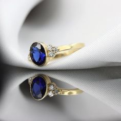 Gorgeous vintage inspired Sapphire ring with DiamondsBezel set with a deep blue Sapphire gemstoneHandmade by an inspired jewelry artist team with decades of experience in the craft of jewelry making.Each gemstone, each diamond is carefully picked.Using only the finest raw materials and the highest industry standard in manufacturing, design and finish.A beautiful vintage inspired piece handmade just for you.Ring Features:- Gemstone info: 8x6 mm blue Sapphire,  Grade AAA, Oval cut, 1.26ct - Second Elegant Sapphire Signet Ring, Timeless 14k Stamped Oval Sapphire Ring, Timeless Oval Sapphire Ring Stamped 14k, Fine Jewelry Oval Sapphire Signet Ring, Oval Sapphire Signet Ring Fine Jewelry, Oval Sapphire Signet Ring In Fine Jewelry Style, Oval Sapphire Signet Ring In 14k Gold, Elegant Oval Sapphire Signet Ring, Elegant Blue Sapphire Signet Ring