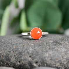 Carnelian, a bright orange agate, is thought to enhance creativity. . . who knew? It is also the gemstone to give for a 17th wedding anniversary.  This simple sterling silver stacking ring is a great gift, or an addition to a collection of stacking rings.  Here are the details:   This ring is made with a 6mm or 8mm bez Sterling Silver Orange Gemstone Rings, Sterling Silver Rings With Orange Gemstone, Sterling Silver Gemstone Ring In Orange, Orange Gemstone Ring In Sterling Silver, Orange Sterling Silver Promise Ring Jewelry, Orange Birthstone Jewelry For Promise Ring, Orange Moonstone Ring As A Gift, Orange Moonstone Ring Gift, Minimalist Orange Round Jewelry