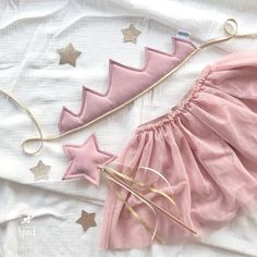 a pink dress with gold stars on it