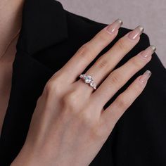 a woman's hand wearing a diamond ring