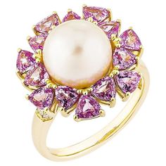 Presented an exquisite ring of pearls and pink sapphire that perfectly combine appeal and refinement. The opulent 18-karat yellow gold creates this gorgeous combination, with glossy white pearls exquisitely paired with vivid pink sapphire. It is ideal for any occasion and instantly elevates formal and informal attire. White Pearl Fancy Ring in 18 Karat Yellow Gold with Pink Sapphire and White Diamond. White Pearl: 6.05 carat, 9.50mm size, round shape. Pink Sapphire: 2.84 carat, 3.5X3.5mm size, trillion shape. White Diamond: 0.05 carat, 1.30mm size, round shape, G color, VS clarity. Gold: 5.35g, 18Karat Yellow Gold. R1802 Informal Attire, Fancy Rings, Yellow Gold Setting, Sky Blue Topaz, Citrine Ring, Modern Ring, Swiss Blue Topaz, Sapphire Stone, Gold Set