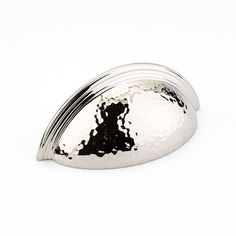 a shiny metal object on a white background