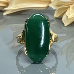 "Oval Green Jade Gemstone and Sterling Silver, Yellow or Rose Gold Filled Wire Wrapped Statement Ring; Custom Made to Size MATERIALS: ❀This large oval Green Jade gemstone wire wrapped ring is handmade with an approximately 20mm by 10mm semi precious gemstone bead and your choice of wire for the band. SIZING: ❀  This ring (as well as all the others in my shop) is custom made to any size from 4 to 14 including half and quarter sizes!  DIRECTIONS FOR CHECKOUT To checkout, please select the SIZE of Wire Wrapped Ring, Jade Gemstone, Wire Wrapped Rings, Argentium Silver, Wrap Rings, Green Jade, Jade Green, Silver Rose Gold, Sterling Ring