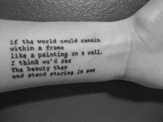 a person with a tattoo on their wrist that says if the world could remain within a frame like a painting on a wall, i think we'd see the beauty then