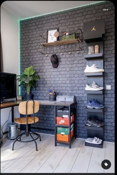 a room with a brick wall and shelves filled with shoes, bookshelves and a desk