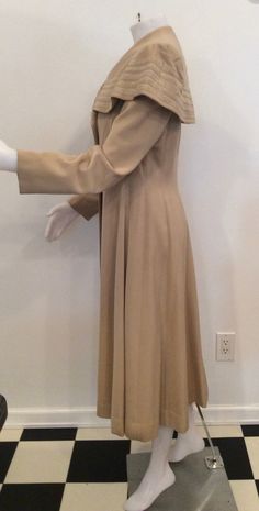 "This is just the most gorgeous 1930's that I've ever seen. Beige or light tan gabardine, I believe, lined in crepe. Fabulous attach collar almost cape like with soutache trim. All original buttons. I'm not sure if one is missing or if that is the design, either way I think it looks great. The most minimal flea bites, see photos. Shown on my mannequin 34 1/2\"/26\"36\" My measurements taken flat Bust 18\" Waist 15\" Total length measuring from shoulder seam to edge 46 1/2\" Simply a beautiful co Beige Coat, Albany Ny, Theatre Costumes, Cape Coat, Vintage Coat, Light Tan, Theater, Looks Great, Vintage Ladies