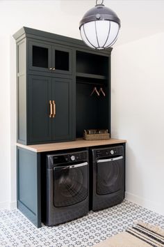 a washer and dryer in a laundry room with an open cabinet above it