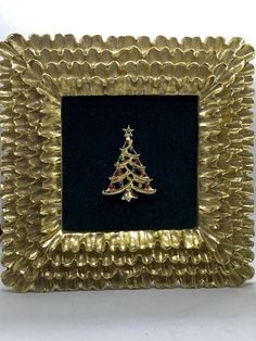 a gold frame with a christmas tree on it