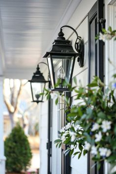 an old fashioned lantern hanging on the side of a house