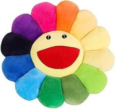 a multicolored flower shaped plush toy with a smiling face on it's side