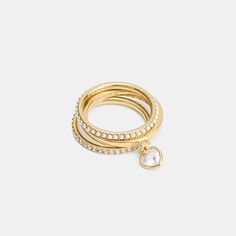 This set of stackable rings add a touch of sparkle to any look. It includes one luminous glass pearl band one shimmering pavé crystal band and a bezel-set crystal heart ring. Wear together or separately. | Coach Pearl Heart Ring Set - Women's Size 8 - Gold/pearl Stackable Gold Rings, Coach Ring, Anchor Ring, Accessory Inspo, Coach Jewelry, Gold Rings Stackable, Clothing Pieces, Pearl Heart, Pandora Rings