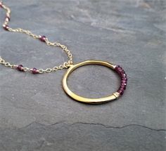 This item is made to order please allow 5 to 8 business days for your order to ship. This circle necklace was This necklace measures 16 inches in length and has a 2 inch extension chain for easy adjusting. The gold filled chain is intertwined with faceted rhodolite rondelle beads, the circle is completely handmade from 0.925 sterling silver followed by a heavy 14k gold plating and finished with genuine rhodolite rondelle beads. Gold Garnet Round Pendant Jewelry, Crescent Necklace, Rhodolite Garnet, Circle Necklace, Chain Jewelry, Stunning Necklace, Sea Glass Jewelry, Moon Necklace, Circle Pendant