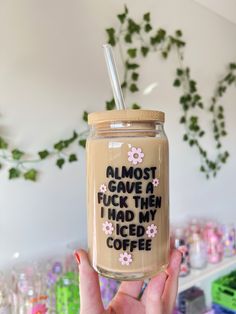 a person holding up a mason jar with the words almost gave me i had my iced coffee on it