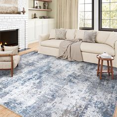 a living room with a couch, chair and fireplace