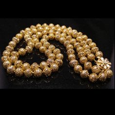 *Description: Beautiful filigree gold tone beaded necklace made in Hong Kong during the 1950s. The Lucite clear beads are covered with gold tone filigree caps with two strands. The clasp is a floral gold tone design which is a box clasp style. The beads are 10mm in length and are beautiful shiny gold tone. Very light weight necklace. This would be a great addition to your vintage jewelry collection or make a great vintage gift! *Approximate Measurements: Length of shortest strand - 22 Inches *Co Gold Double Strand Jewelry For Festive Occasions, Formal Gold Beaded Necklaces, Vintage Gold Polished Beads, Vintage Polished Gold Beads, Yellow Gold Beaded Necklaces For Formal Occasions, Formal Yellow Gold Beaded Necklaces, Elegant Gold Beaded Necklace With Large Beads, Antique Large Gold Beads, Antique Gold Polished Beads