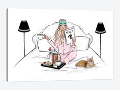 a woman in pink pajamas sitting on a bed next to a cat and holding a sign