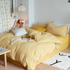 a bed with yellow and white checkered sheets