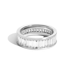 The Landmark Series celebrates love in NYC. Inspired by the structural boldness of iconic New York architecture, the collection captures the essence of Gotham. This diamond baguette eternity band was designed to represent the footprint and buildings of the iconic Rockefeller Center. Each piece empowers the wearer to reveal romance by making their very own love landmark. Baguettes are vertically channel set 360 degrees. Luxury Baguette Diamond Eternity Band For Anniversary, Modern Rings With Baguette Diamonds, Luxury White Gold Eternity Band With Baguette Cut, White Gold Baguette Channel Set Jewelry, Luxury White Gold Baguette Cut Eternity Band, Modern Platinum Rings With Baguette Diamonds, Modern Baguette Cut Rings For Everyday Luxury, Luxury Baguette Cut Eternity Band For Anniversary, Modern Channel Set Eternity Band For Anniversary