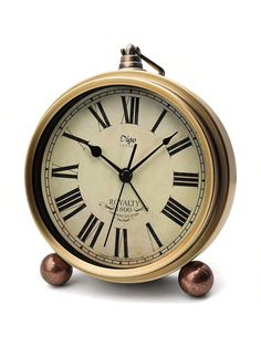 an old fashioned clock with roman numerals on it