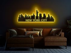 the new york city neon sign is lit up against a dark wall in this living room