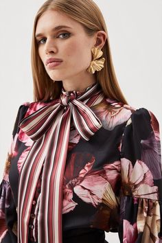 This Elegant Blouse Promises To Elevate Every Wear. Long Balloon Sleeves Are Updated With A Cuffed Detail For A Classic Touch, While A Botanical Print And High Neck Tie Detail Ensures A Feminine Yet Modern Finish. Style This Blouse With Sleek Tailored Trousers And Heels.Floral Printlong Sleevehigh Necktie Detail Chic Puff Sleeve Blouse With Floral Print, Elegant Floral Print Tie Neck Blouse, Chic Floral Print Blouse With Balloon Sleeves, Chic Floral Print Balloon Sleeve Blouse, Chic Balloon Sleeve Blouse With Floral Print, Chic Office Blouse With Floral Print, Elegant Floral Print Blouse With Puff Sleeves, Elegant Floral Print Blouse With Bishop Sleeves, Floral Print Tie Neck Blouse For Work