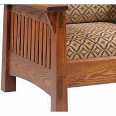 a close up of a wooden chair with a patterned seat cushion on the armrests