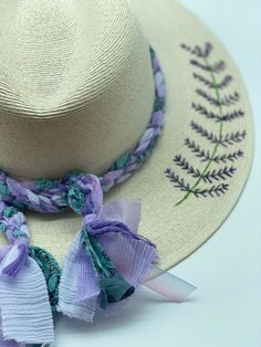 Embroidered Lavender on Brim by Corazon Playero Custom designed and hand made hats by artisans in San Jose Del Cabo, Mexico. These hats are one size fits most with an elastic band inside to add comfort and fit for all head sizes. Each hat has a 3-4 week turnaround. Please note, all hats come with natural braid unless custom braid is purchased. Handmade Adjustable Sun Hat For Kentucky Derby, Adjustable Purple Hats For Vacation, Handmade Adjustable Whimsical Straw Hat, Whimsical Adjustable Straw Hat With Curved Brim, Embroidery On Straw Hat, Adjustable Lavender Hat For Kentucky Derby, Lavender Wide Brim Hat For Kentucky Derby, Lavender Adjustable Hat For Kentucky Derby, Purple Fedora For Beach