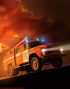 an orange fire truck driving down a road at night with bright lights on it's roof