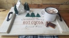 a tray that has some food on it and a cup with hot cocoa in it