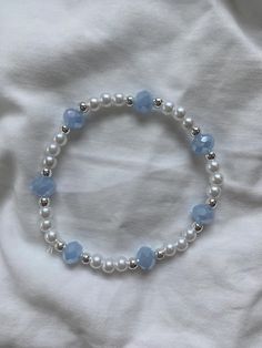 Pearl with light blue and silver accents, this beautiful bracelet makes for the perfect accessory for going out Light Blue Jewelry, Bracelet Aesthetic, Silver Pearl Bracelet, Aesthetic Accessories, Blue Beaded Bracelets, Diy Jewlery, Beaded Jewelry Tutorials, Phone Strap, Bracelet Ideas