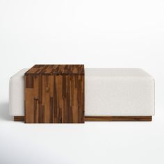 a wooden bench with white upholstered fabric and wood trim on the bottom part