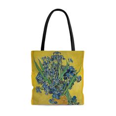 a yellow tote bag with blue irises on the outside and green stems in it