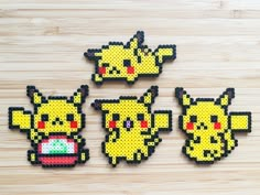 four pixelated images of pikachu and other pokemon characters on a wooden surface