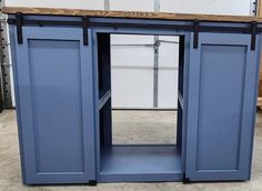 a large blue cabinet with two doors open