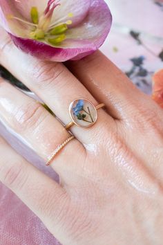 This ring features a beautiful Forget Me Not flower, a symbol of remembrance and everlasting love. The intricate details of the flower are captured perfectly, with each petal and stem carefully preserved to showcase its delicate beauty. The flower is encased in an oval, gold-filled frame, adding a touch of elegance to the design. The ring is made of high-quality gold fill, ensuring that it will remain radiant and beautiful for years to come. ………………………………….DETAILS• FACE is Gold Filled, measuring Delicate Flower Birth Flower Jewelry, Elegant Petal Flower Ring Gift, Elegant Petal Shaped Flower Ring As Gift, Rose Gold Flower-shaped Promise Ring, Nature-inspired Flower Wedding Rings, Birth Flower Ring For Promise, Rose Gold Flower Ring For Promise, Rose Gold Flower Promise Ring, Adjustable Delicate Flower Promise Ring