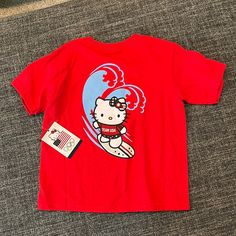 Team Usa Hello Kitty Surfing Olympics 3t T-Shirt Nwt Playful Red Character Print T-shirt, Red Cotton Hello Kitty T-shirt, Red Hello Kitty Print Crew Neck Top, Red Hello Kitty Short Sleeve Tops, Red Crew Neck Top With Hello Kitty Print, Casual Red Hello Kitty Top, Red Cotton T-shirt With Cartoon Print, Playful Red T-shirt With Character Print, Playful Red T-shirt With Cartoon Print