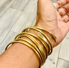 These brass bangles are a stunning addition to any jewelry collection. Handcrafted with care, this set of adjustable bracelets is perfect for anyone who loves to mix and match their accessories. Each bangle has a beautiful gold finish that adds a touch of elegance and sophistication to any outfit. These bangles are not only stylish, but also incredibly versatile. They can be worn alone as a statement piece or stacked together for a more boho-inspired look. The adjustable design makes them easy to wear and comfortable for all-day wear. This set is perfect for those who want to add a touch of elegance to their everyday wardrobe. Whether you're dressing up for a special occasion or simply adding some flair to your work-from-home outfit, these brass bangles are sure to elevate your style. Plus Stackable Brass Bangle Bracelets, Stackable Brass Bangle For Gift, Stackable Brass Bangle As Gift, Stackable Brass Bangle Gift, Adjustable Stackable Brass Bracelets, Adjustable Flexible Bangle For Gifts, Copper Choker, Elephant Bangle, Bracelets Adjustable