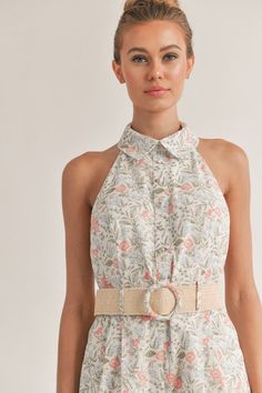 Embrace the bloomy side of life with our Floral Print Romper with Belt. This versatile design is your ticket to a stylish and comfortable look this summer. With a stunning floral print that exudes freshness, a flattering halter neckline, and a belt to cinch around the waist, this romper is a must-have in your wardrobe. Stay organized and stylish with convenient pockets to store your essentials while you take on your next adventure. Unleash your wild side and live life to the fullest in this chic Feminine Halter Neck Top For Vacation, Chic Floral Print Halter Top For Day Out, Chic Floral Print Halter Top, Feminine Sleeveless Halter Top For Summer, Spring Floral Print Halter Top For Beach, Summer Floral Print Halter Top For Day Out, Sleeveless Floral Print Halter Top For Spring, Feminine Spring Vacation Halter Top, Feminine Halter Top For Spring Vacation