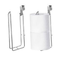 two rolls of toilet paper are next to a metal holder and one roll is hanging on the wall