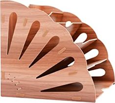 three wooden utensils with holes in them