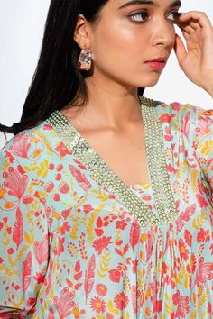 Green asymmetric kurta with all over floral print and sequin bead embellishments. Comes with straight pant. - Aza Fashions Summer Anarkali Floral Print Sets, Summer Anarkali Set With Floral Print, Festive V-neck Set With Floral Print, Festive Floral Print V-neck Set, Bollywood Style Summer Floral Sets, Spring Anarkali Kurta With V-neck, Summer V-neck Kurta With Printed Motifs, Anarkali Sets With Floral Print And V-neck, Summer Anarkali Set With V-neck