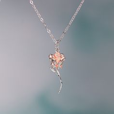 This exquisite rose pendant necklace showcases a 3D rose in 925 sterling silver with rose gold plating for a stunning flower color. It hangs delicately on a 925 sterling silver cable pendant with an adjustable ball. Make this elegant rose pendant necklace a part of your everyday fine jewelry collection, or gift it to a loved one for a special occasion. Materials: 925 sterling silverFinish: platinum plate, rose gold plateMaximum length is 17.5 inches, can be adjusted shorter using the adjustable ball. Jewelry Care: See more information about how to care for your jewelry here. Shipping Policy: Orders will be shipped within 1-3 business days. Economy shipping will take 7-14 days to arrive and standard shipping is 1- 4 days for U.S. orders. International shipping time is depended on the countr Rose Gold Flower Pendant Clavicle Necklace, Rose Gold Flower Pendant Necklace With Roses, Sterling Silver Rose Gold Jewelry With Rose Design, Rose Gold Necklace With Flower Pendant And Roses, Rose Gold Necklace With Flower Pendant, Rose Gold Clavicle Chain Necklace With Flower Pendant, Rose Gold Necklace With Flower Pendant And Delicate Chain, Delicate Rose Gold Necklaces With Roses, Dainty Rose Gold Necklace With Rose Design