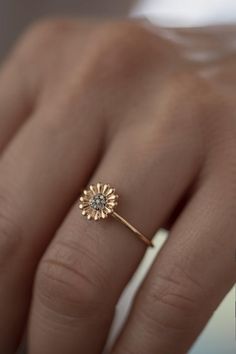 Feeling bohemian?Take this ultra feminine  minimalistic boho daisy ring and declare yourself a champion of laid back cool.Handmade to order in 14K solid Rose Gold with a delicate band, this is not your ordinary daisy motif.Flower power is here to stay and has never looked so good!This is a modern way to wear floral jewelry as imagined by Atelier Petites Pierres, proprietors of beautiful jewelry fashioned from high quality materials and craftsmanship.A fourteen petal design sculpted in light reli Dainty 14k Gold Flower Ring For Wedding, Delicate Yellow Gold Jewelry For Proposal, 14k Rose Gold Flower Ring With Birth Flower, Promise Flower Ring With Rose Cut Diamonds, Promise Rose Cut Diamond Flower Ring, Rose Gold Flower-shaped Promise Ring, Fine Jewelry Flower Ring For Proposal, Adjustable Delicate Flower Promise Ring, Rose Gold Flower Ring For Promise