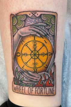 a close up of a person's leg with a tattoo on it that says wheel of fortune