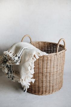 a woven basket with a white cloth in it